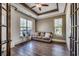 Comfortable living room with a tray ceiling, sofa, and two large windows at 2131 Timmerman Rd., Myrtle Beach, SC 29588