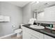 Bathroom featuring a toilet, white cabinets, black countertop and white walls at 2151 Bridge View Ct. # 2705, North Myrtle Beach, SC 29582