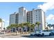 Beautiful condo building with palm trees and well-manicured landscaping at 2151 Bridge View Ct. # 2705, North Myrtle Beach, SC 29582