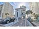 Exterior view of condo building featuring a gated parking area with palm trees at 2151 Bridge View Ct. # 2705, North Myrtle Beach, SC 29582