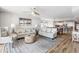 Open-concept living room featuring hardwood floors, a ceiling fan, comfortable seating, and access to dining area at 2151 Bridge View Ct. # 2705, North Myrtle Beach, SC 29582