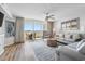 Bright living room with comfortable seating, wood flooring, ceiling fan, and sliding glass doors to the balcony at 2151 Bridge View Ct. # 2705, North Myrtle Beach, SC 29582