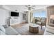 Cozy living room featuring wood floors, a ceiling fan, balcony access, and stylish decor at 2151 Bridge View Ct. # 2705, North Myrtle Beach, SC 29582