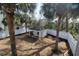 Landscaped backyard with a charming cabana, white picket fence, and mature palm trees at 220 Starcrest Circle, North Myrtle Beach, SC 29582