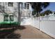 Driveway leading to a two-car garage with a well-maintained white privacy fence at 220 Starcrest Circle, North Myrtle Beach, SC 29582