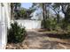 Brick paved driveway leading to gate with lush landscaping and backyard views at 220 Starcrest Circle, North Myrtle Beach, SC 29582