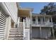 Inviting entryway with a staircase, white railings, and access to the garage and living space at 220 Starcrest Circle, North Myrtle Beach, SC 29582