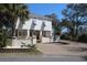 Two-story coastal home with brick paved drive, landscaping, and a peek at the exterior finishes at 220 Starcrest Circle, North Myrtle Beach, SC 29582