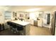 Bright kitchen featuring white cabinets, stainless steel appliances, and a breakfast bar with seating at 220 Starcrest Circle, North Myrtle Beach, SC 29582