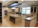 Bright kitchen with cream-colored cabinets, stainless steel appliances, and large central island at 220 Starcrest Circle, North Myrtle Beach, SC 29582