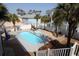 Backyard oasis featuring a private pool, hot tub, and well-manicured landscaping with palm trees at 220 Starcrest Circle, North Myrtle Beach, SC 29582