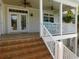 Front porch with tiled stairs, white railings, and ceiling fans at 220 Starcrest Circle, North Myrtle Beach, SC 29582