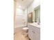 Bathroom with a shower/tub combo, white vanity, white cabinets, and framed artwork at 242 Warner Crossing Way, Loris, SC 29569