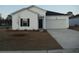Charming single-Gathering home featuring vinyl siding, a two-car garage, and a well-manicured lawn at 242 Warner Crossing Way, Loris, SC 29569