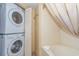 Bathroom area featuring a stacked washer and dryer and a bathtub with shower, offering laundry convenience at 2504 Ocean Blvd. # 1134, Myrtle Beach, SC 29577