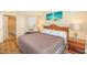 Bedroom with a cozy bed, beach-themed decor, and an ensuite bathroom for added convenience at 2504 Ocean Blvd. # 1134, Myrtle Beach, SC 29577