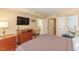Comfortable bedroom features an ensuite bathroom, television, and ample storage space at 2504 Ocean Blvd. # 1134, Myrtle Beach, SC 29577