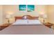 Bedroom features lamps on the side tables, a comfortable bed and nautical themed wall art at 2504 Ocean Blvd. # 1134, Myrtle Beach, SC 29577