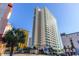 Modern condo exterior showcasing architectural details and location along a busy street with palm trees at 2504 Ocean Blvd. # 1134, Myrtle Beach, SC 29577