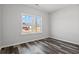 Bedroom features luxury vinyl plank flooring and a bright window view of the neighborhood at 272 Stillbrook Dr., Longs, SC 29568