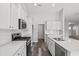 Bright kitchen featuring white cabinetry, stainless steel appliances, and wood-look flooring at 272 Stillbrook Dr., Longs, SC 29568