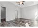 Main bedroom featuring neutral paint, wood-look flooring, ceiling fan, and doors to closet and the bathroom at 272 Stillbrook Dr., Longs, SC 29568