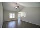 Bright living room with ceiling fan, wood floors, and large window providing natural light at 275 Stillbrook Dr., Longs, SC 29568