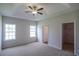 Spacious main bedroom features a tray ceiling, carpet flooring, and natural light from two windows at 275 Stillbrook Dr., Longs, SC 29568