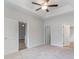 Spacious primary bedroom showcasing a ceiling fan and multiple doorways leading to other areas of the home at 276 Stillbrook Dr., Longs, SC 29568