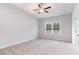 Relaxing bedroom features a ceiling fan and tray ceiling and a large window with lovely outside views at 276 Stillbrook Dr., Longs, SC 29568