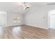 Spacious living room with wood-look floors, high ceilings, a ceiling fan and plenty of natural light at 276 Stillbrook Dr., Longs, SC 29568