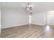 Bright and airy living room with wood-look flooring, ceiling fan, and neutral wall color at 276 Stillbrook Dr., Longs, SC 29568
