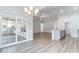Open-concept living area showcasing wood-look floors, and seamlessly connects the dining, living, and kitchen spaces at 276 Stillbrook Dr., Longs, SC 29568