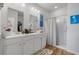 Bright bathroom with dual sinks, framed mirrors, and walk-in shower at 2882 Ophelia Way, Myrtle Beach, SC 29577