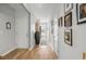 Bright hallway leads to various rooms, adorned with stylish decor, including framed portraits at 2882 Ophelia Way, Myrtle Beach, SC 29577