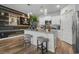 Modern kitchen features an island with bar seating, stylish lighting and stainless appliances at 2882 Ophelia Way, Myrtle Beach, SC 29577