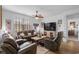 Cozy living room with plush leather seating, ceiling fan, and ample natural light creating an inviting atmosphere at 2882 Ophelia Way, Myrtle Beach, SC 29577