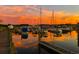 Scenic waterfront view with boats docked against a vibrant sunset sky at 3026 Cedar Creek Run, Little River, SC 29566