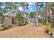 Backyard view of a home featuring a patio with outdoor seating and mature trees at 3026 Cedar Creek Run, Little River, SC 29566