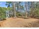 Spacious backyard with mature trees and an outdoor seating area at 3026 Cedar Creek Run, Little River, SC 29566