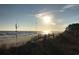 Beach at sunset with blue skies and a boardwalk near an oceanfront condominium at 3026 Cedar Creek Run, Little River, SC 29566
