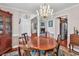 Charming dining room with hardwood floors, chandelier and view into the living room at 3026 Cedar Creek Run, Little River, SC 29566
