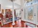 Elegant foyer with hardwood floors, decorative door, and a dining area showcasing refined taste at 3026 Cedar Creek Run, Little River, SC 29566