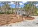 Spacious front yard with mature trees and well-maintained landscaping along the driveway at 3026 Cedar Creek Run, Little River, SC 29566