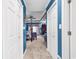 Hallway view of main bedroom with blue walls, carpeted flooring and white doors and trim at 3026 Cedar Creek Run, Little River, SC 29566