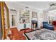 Cozy living room featuring fireplace, built-in shelving, wood floors, and sitting area at 3026 Cedar Creek Run, Little River, SC 29566