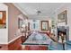 Bright living room with cherry floors, fireplace, seating area and elegant front door at 3026 Cedar Creek Run, Little River, SC 29566
