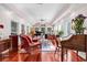 Expansive living room with many windows, piano, comfortable seating, and hardwood floors at 3026 Cedar Creek Run, Little River, SC 29566