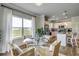 Bright dining area with a glass table, seating for four, and a view of the well-manicured yard at 309 Mayflower Dr., Calabash, NC 28467