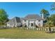 Stunning gray home showcasing well-maintained landscaping and vibrant greenery at 3700 Waterford Dr., Myrtle Beach, SC 29577